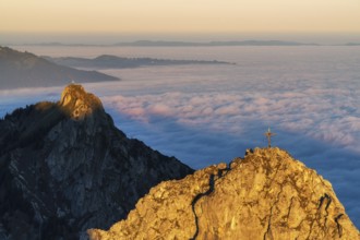 Peaks im Ammergauer Alpen alps at sunrise, above the clouds in the valley