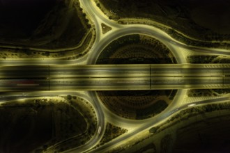 Aerial drone top view of motorway junction. Roundabout with cars moving. Transportation