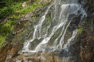 Waterfall of fresh water in the mountain in autumn. Alsace, France, Europe