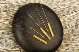 Several needles for acupuncture are next to each other. Traditional Chinese medicine (alternative