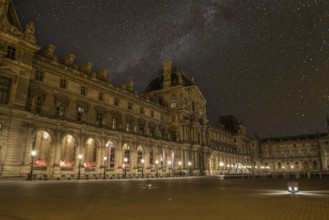 Scenic starry night sky above the Parisian Louvre Palace, France, Europe