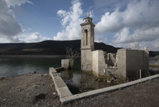 Ruins of an abandoned and deserted church in the water of a dam. Agios Nikolaos Alassa dam Cyprus