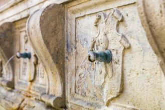 Detail of an ancient fountain in Assisi Italy