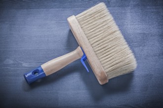 Wood board with paintbrush thick bristle construction concept