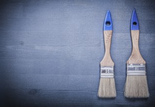Paint brushes on wooden board construction concept