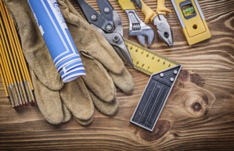 Stack of construction tools on vintage wooden board