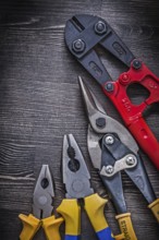 Metal wire steel cutter pliers on wood board construction concept