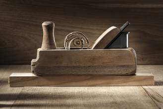 Carpenter tools woodworkers plane on vintage wooden background