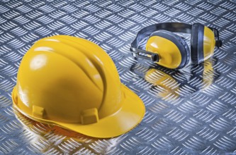 Safety earmuffs hard hat on fluted metal sheet construction concept