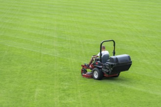 Mowing grass at football pitch in Lubin, Poland, Europe
