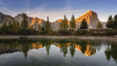 Panorama of the lake Lago di Limedes with the reflection of the surrounding mountains
