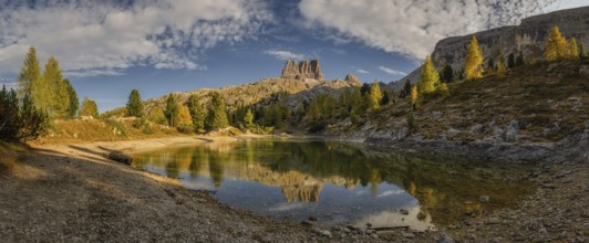 Panorama of the lake Lago di Limedes with the reflection of the surrounding mountains