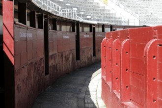Madrid, Spain, Europe, Narrow entrances in the arena with red walls and names of the areas, Las