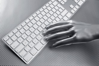 Computer keyboard aluminum gray hand silver background