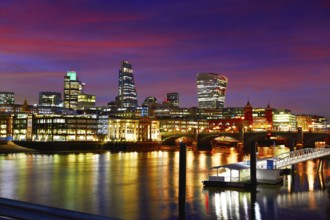 London skyline sunset on Thames river reflection at UK
