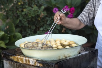 Woman cooking traditional delicious greek loukoumades honey pastry