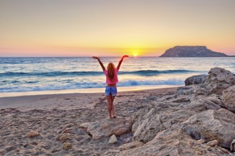 A woman at sunset in Fragolimnionas beach of Karpathos, Greece, Europe