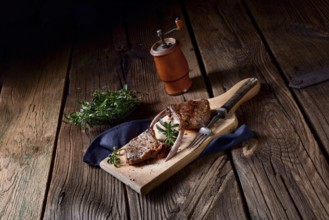 Grilled lamb chops on an old board