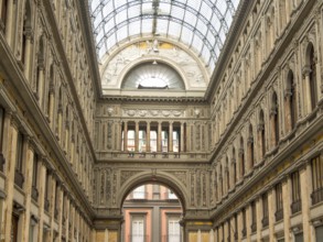 Historic building with high arches and an imposing glass roof that lets in plenty of natural light,