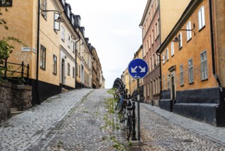 Stockholm, Sweden, August 8, 2019: Bicycles parked in picturesque cobblestoned street in Ugglan