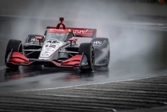 WILL POWER (12) of Toowoomba, Australia comes through turn 12 (Canada Corner) during a wet practice