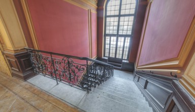 Elegant interior with curved staircase, red walls and large window, Villa Woodstock, Lost Place,