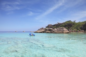 Exotic tropical Similan Islands. Clear azure ocean water. Moored in the bay inflatable boat