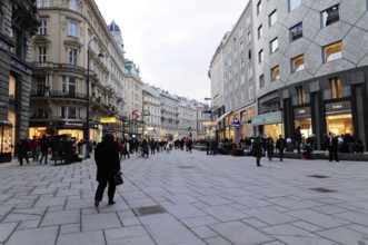 Lively urban square with people and shops along a wide street, Vienna, Austria, Europe
