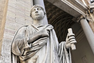 Historical marble statue of a person holding a scroll in front of a classical column structure,