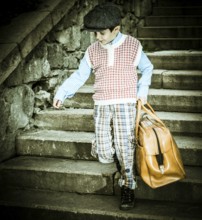 Exterior stairs and child with vintage bag. Vintage clothes style