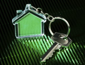 Keychain figure of house and key close up