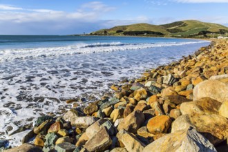 Sunset. Rocky and stone shores of the ocean. The southernmost point of New Zealand. The concept of