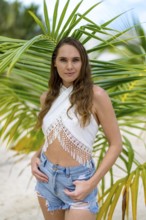 A radiant young woman embraces the Caribbean's charm, her laughter dancing in the warm breeze,