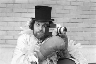 In the 1970s. A man is filming with a amateur film camera. The film was then developed and shown on