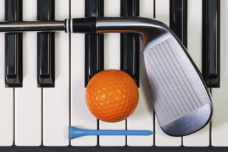 Virtuosic game - Piano keyboard and different golf equipments