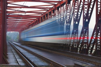 Speed train on the old iron railway bridge, Vsenory, Czech Republic, Europe