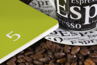 Coffee beans, cup of coffe and diary for May