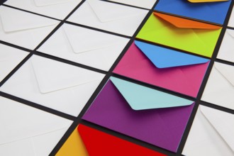 Composition with white and colored envelopes on the table. The photo suitable for various holidays