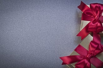 Giftboxes with red tapes on grey background holidays concept