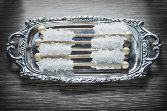 Sweet sugar sticks on metallic tray