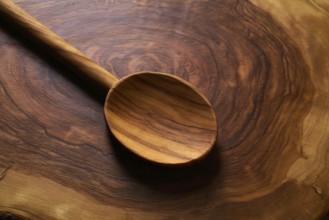 Olive wood spoon on same wooden cutting board