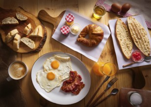 Continental breakfast croissant eggs bacon bread slices orange jiuce