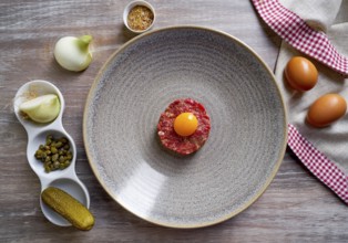 Steak Tartare raw meat recipe with egg yolk modern cuisine