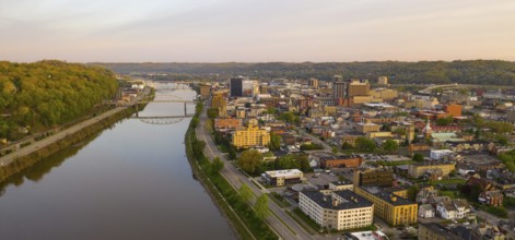 Sunrise reflects in the Kanawha River slowly flowing by picturesque Charleston West Virginia