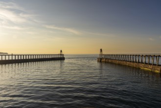 Golden Hour at the West and East Pier in Whitby, North Yorkshire, England, UK