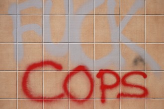 The political slogan Fuck Police on a tiled wall