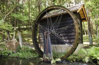 Small Japanese water mill running in the Expo Commemorative Park, Osaka, Osaka, Japan, Asia