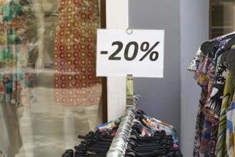 Notice of reduced-price clothing at a shop