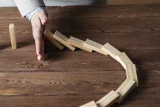 Business woman block domino effect. Business assistance, risk management and stabilisation
