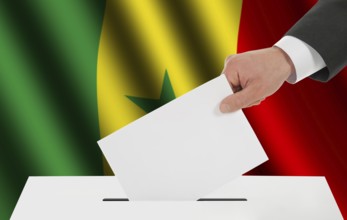 The Senegal flag and the hand with the bulletin about the ballot box